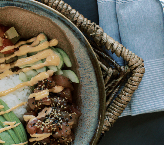 A fresh, colorful ahi tuna poke bowl with avocado and sesame seeds served on an outdoor patio for Father’s Day in Park City.